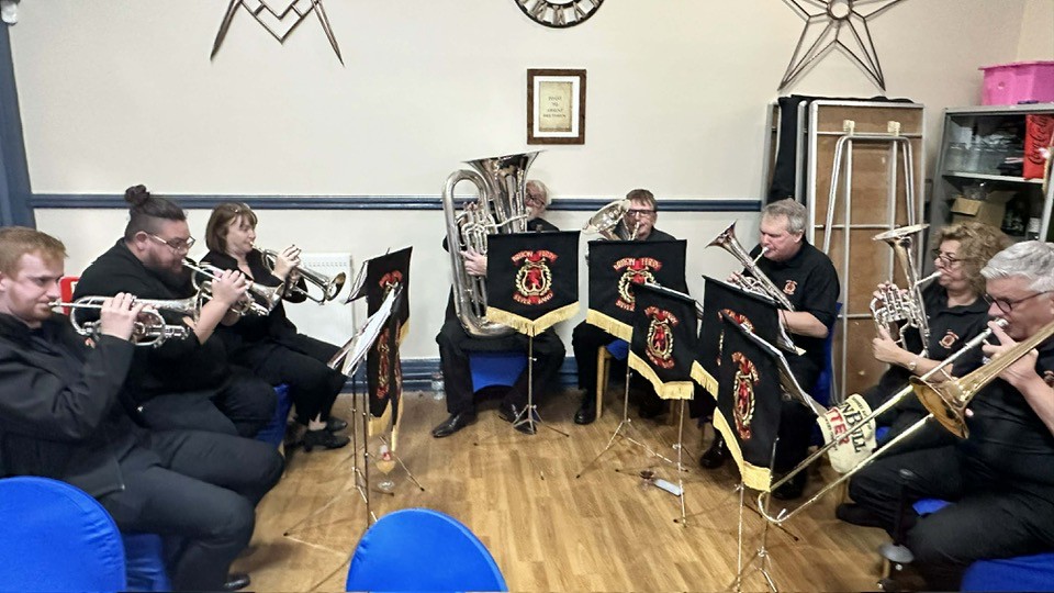 a picture of Briton Ferry Band at a carolling engagement 2025