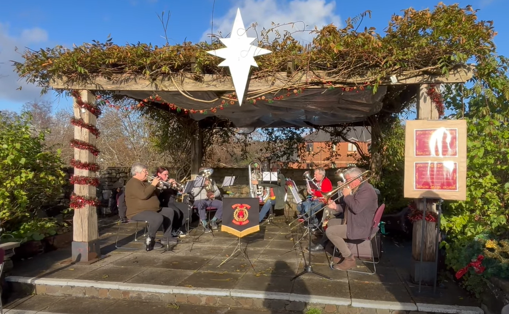 a picture of Briton Ferry Band carolling at Neath Christmas Market, Christmas 2025